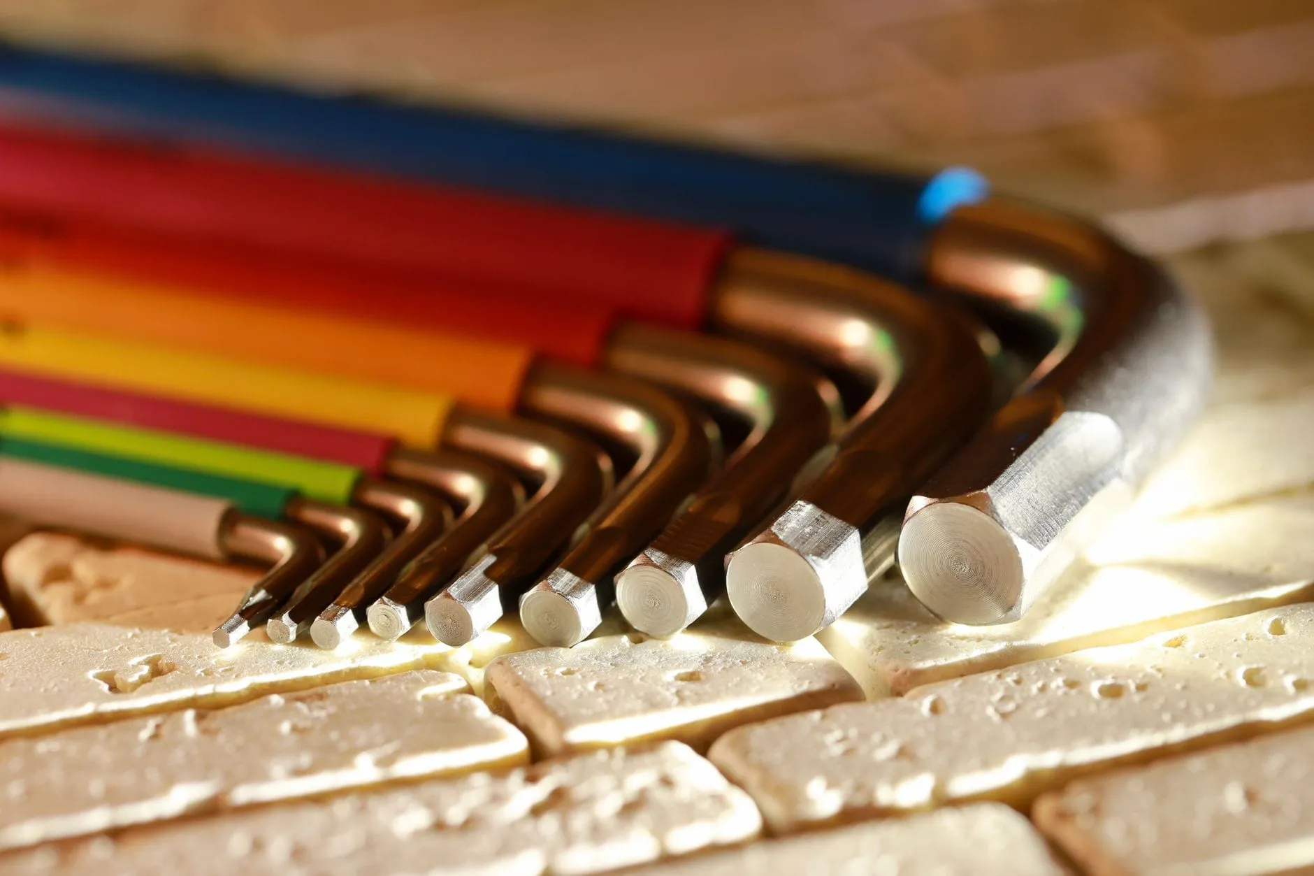 A set of hex keys fanned out from smallest to largest, each with a differently coloured shaft.